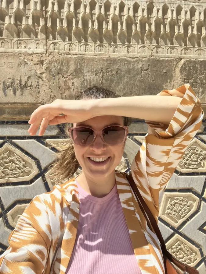 Anna Korol at the tiled madrasa walls of Samarkand, Uzbekistan